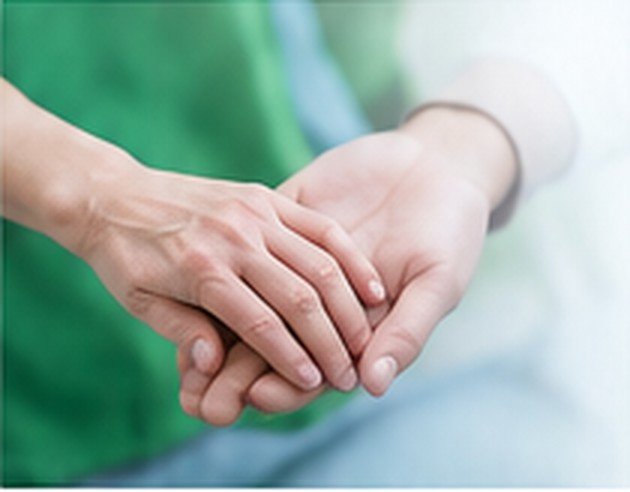Hands providing compassionate patient support